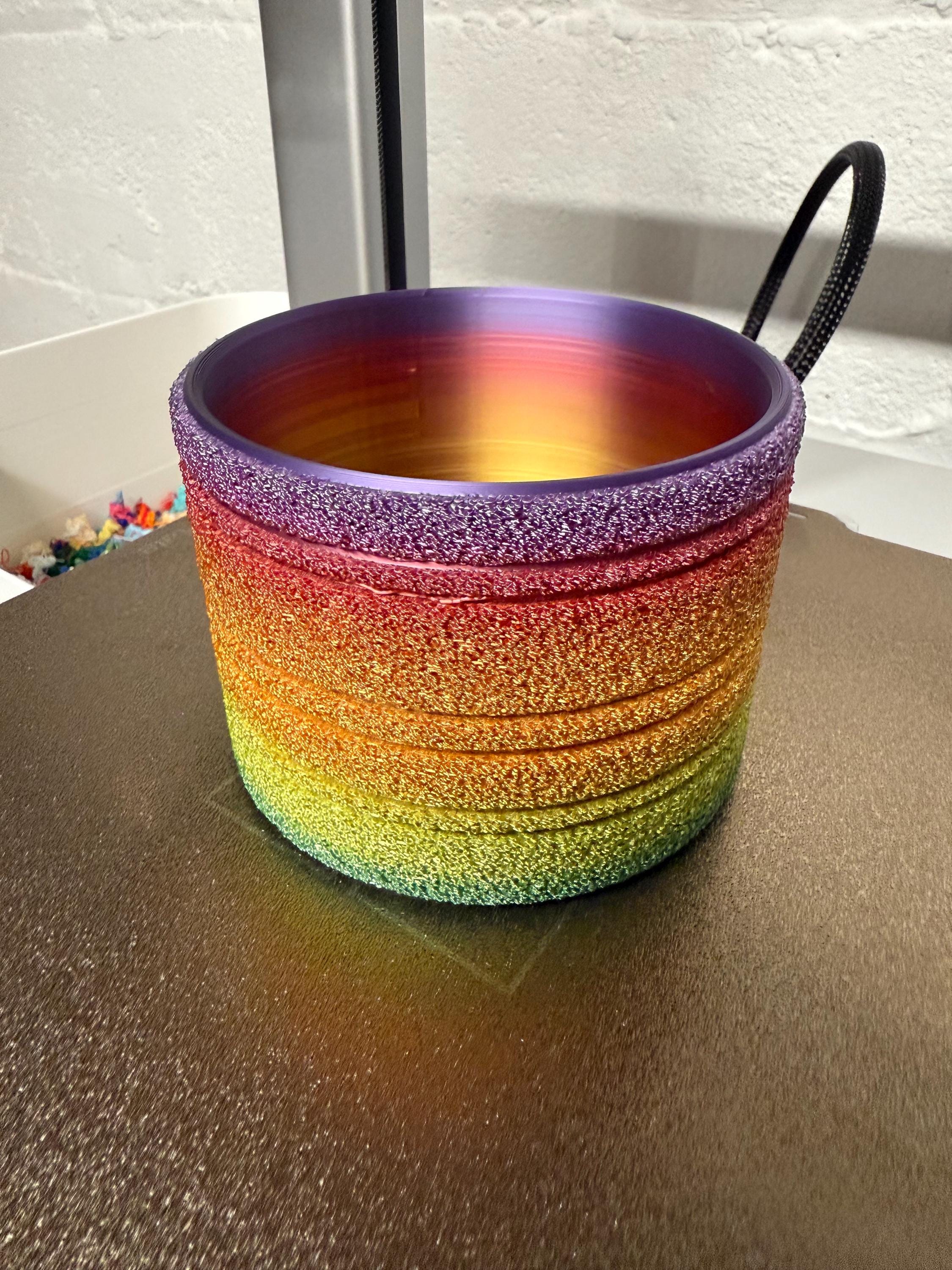 Empty classic rainbow fuzzy planter on the 3D printer bed, showing the interior