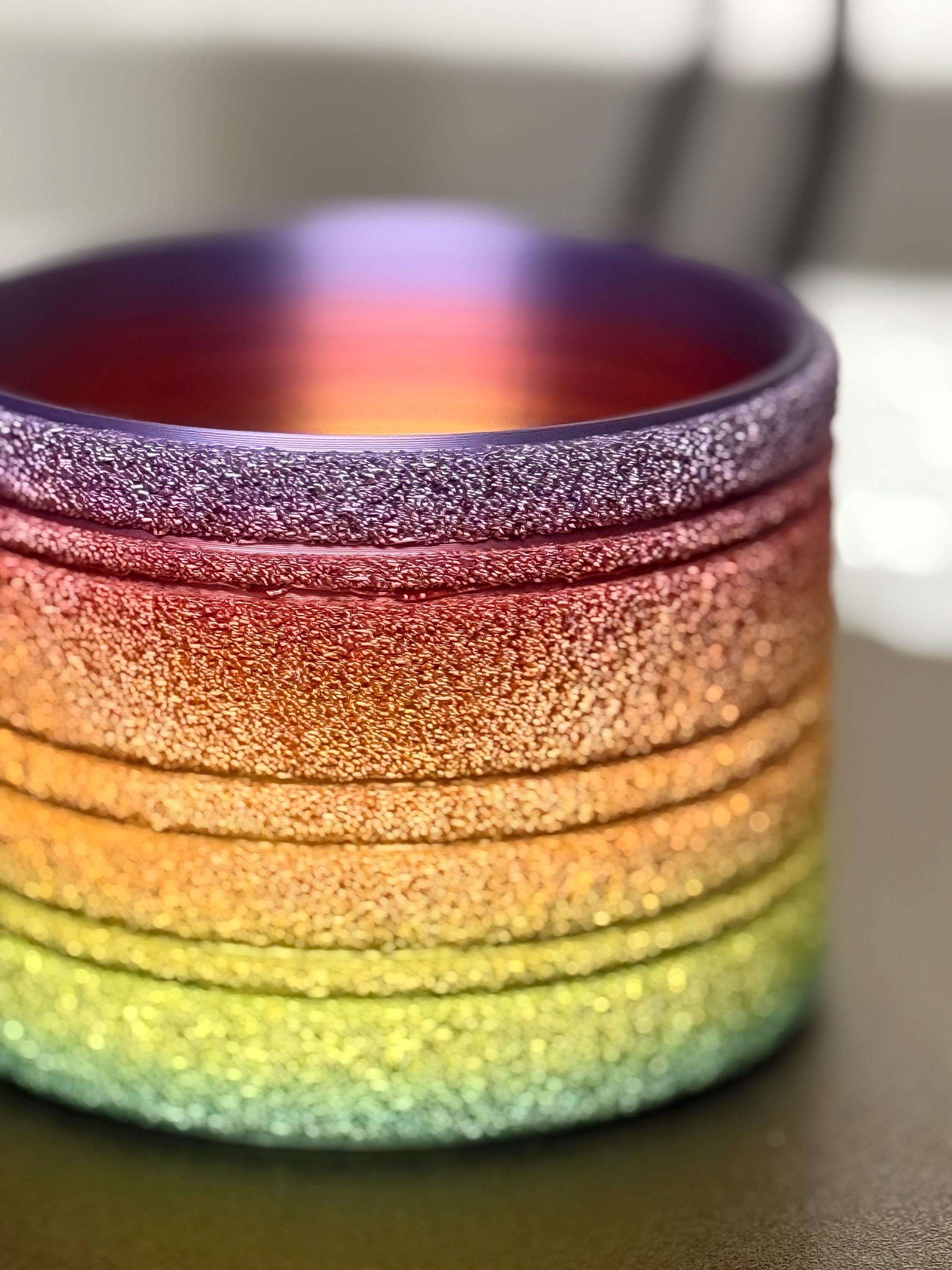 Close-up of the rainbow gradient and ridged fuzzy texture on a 3D printed plant pot