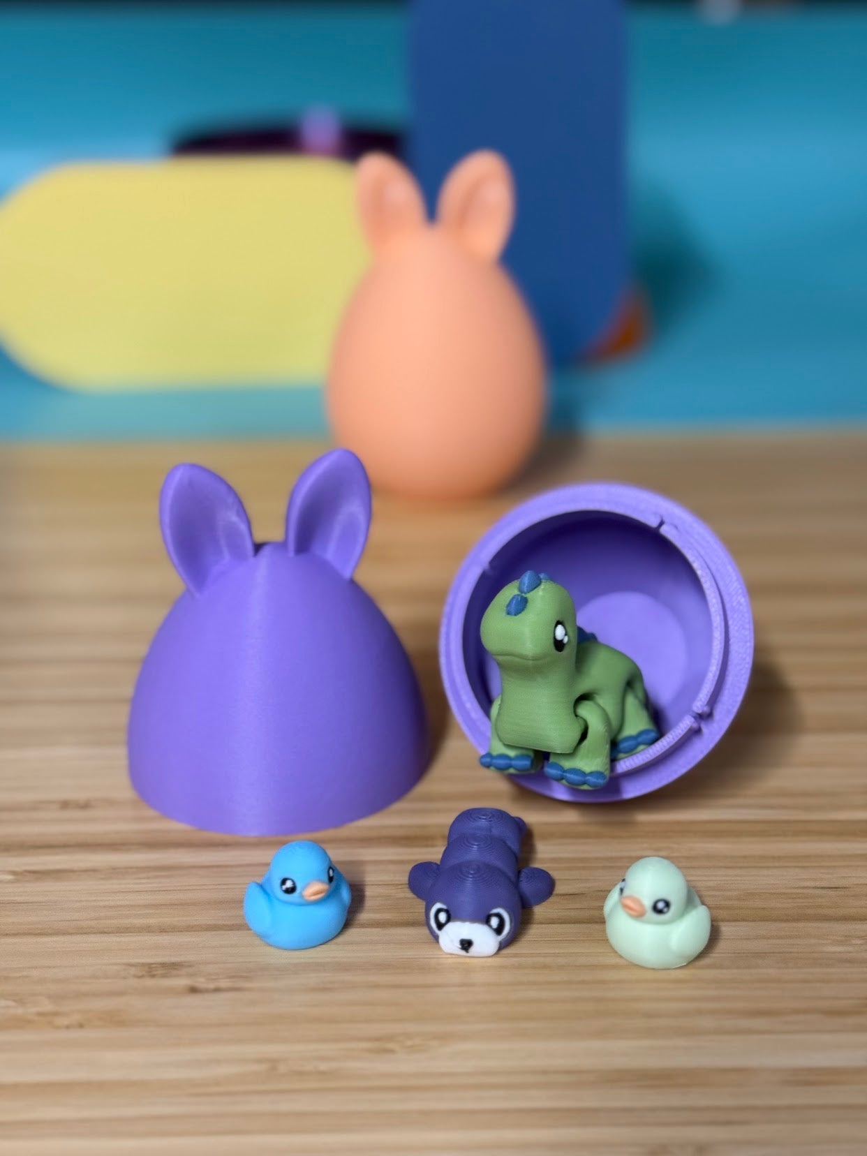Purple bunny ear mystery egg opened to show a small dinosaur, seal, and duck toy inside