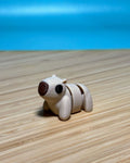 Tan 3D printed Mini Flexi Capybara fidget toy on a wood desk