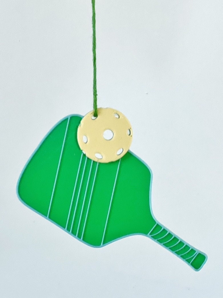 Green pickleball paddle ornament with yellow pickleball on a white background