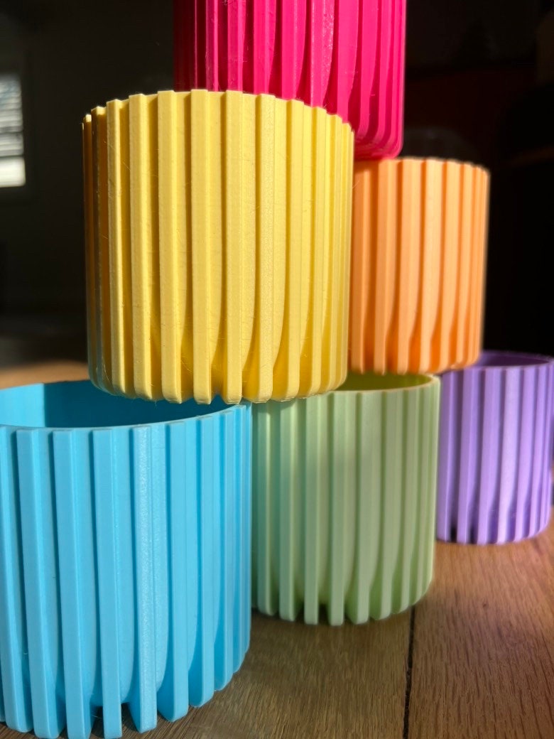 Stacked 3D printed Modern Fluted Planters in yellow, peach, light blue, mint green, lavender and magenta